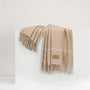 Sand Windowpane Cashmere Throw by Lands Downunder shown draped on white riser