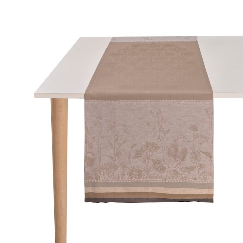 Instant Bucolique Beige Table Runner by Le Jacquard Français shown on White Table