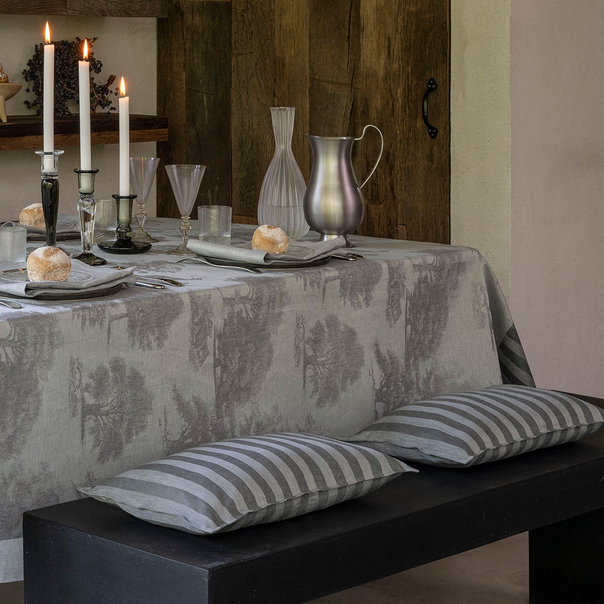 Lifestyle image of table with lumbar cushion covers - Le Jacquard Francais Souveraine Silver