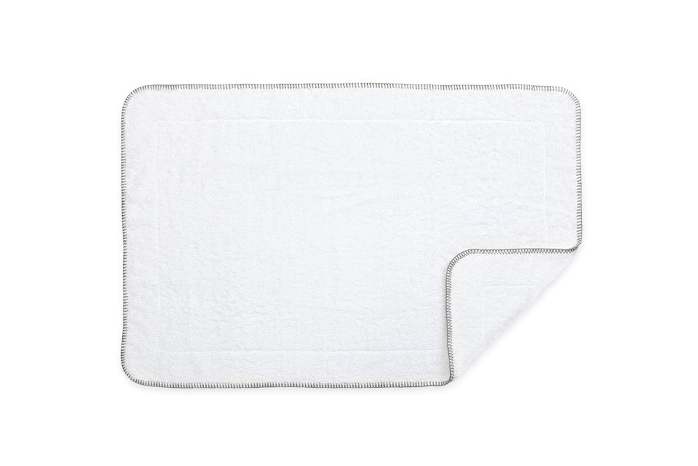 https://www.figlinensandhome.com/cdn/shop/products/Matouk_Whipstitch_Tub_Mat_Nickel_FigLinens.jpg?v=1598651584